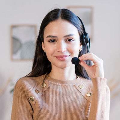 Nosotros 2 smiling woman in headphones standing at the office KYNNHZ6